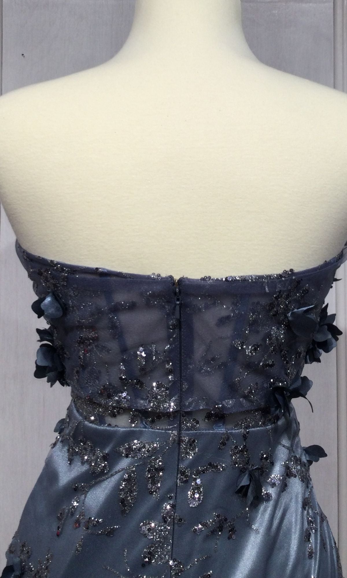Back view of the Off-the-Shoulder Long Glitter Prom Dress J832, a mermaid-style gown featuring sheer mesh, sequin floral embellishments, satin fabric, and a zipper closure.